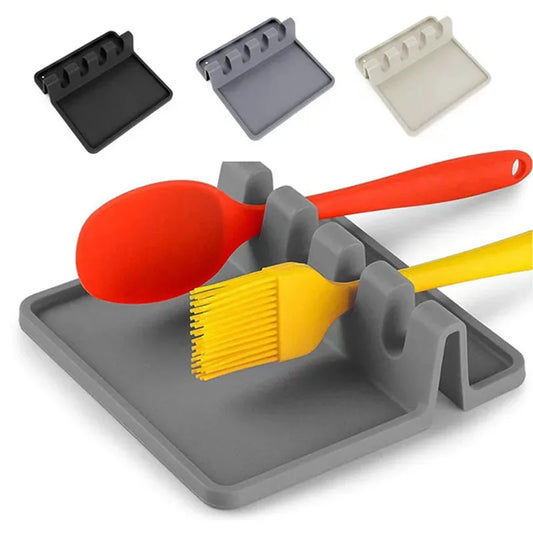 Silicone utensil rest for kitchen use, heat-resistant, easy-to-clean design for holding spoons, spatulas, and cooking tools.  
