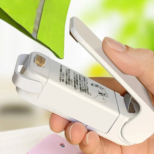 Portable mini heat bag sealer for plastic food bags, battery-powered and compact design for home and travel use.  

