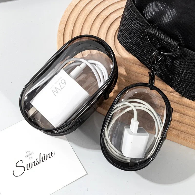 Transparent travel cable organizer case for chargers, earphones, and accessories, waterproof PVC with compact portable design.
